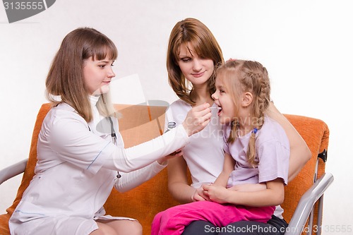 Image of Pediatrician at home gives you a sick child medicine