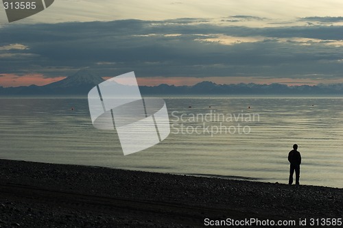 Image of Cook Inlet beach sunset with a man silouette