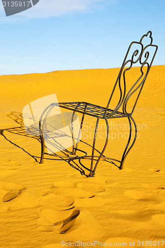 Image of table and seat in desert  sahara   yellow sand