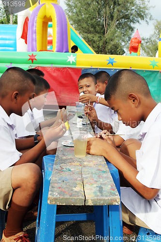 Image of Thai school students painting during art class - EDITORIAL ONLY.