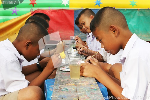 Image of Thai school students painting during art class - EDITORIAL ONLY.