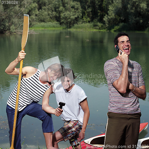 Image of happy men with canoe