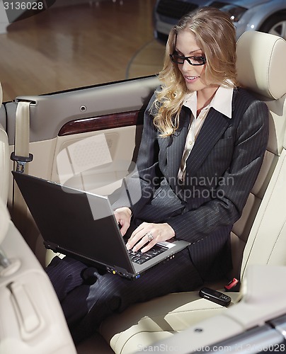Image of businesswoman has a fan with laptop