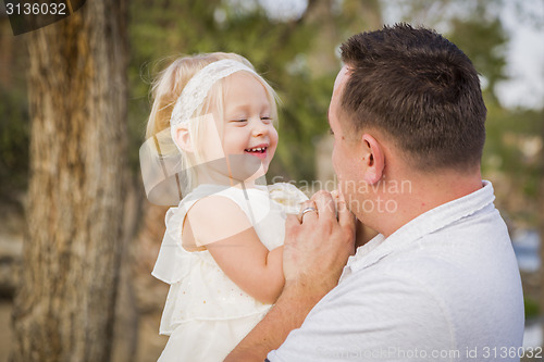 Image of Father Playing With Cute Baby Girl Outside at the Park