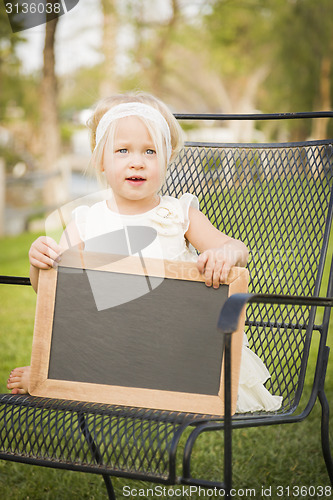 Image of Cute Baby Girl in Chair Holding Blank Blackboard