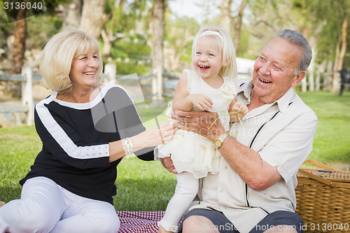 Image of Affectionate Granddaughter and Grandparents Playing At The Park
