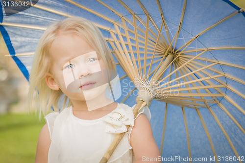 Image of Cute Baby Girl Holding Parasol Outside At Park