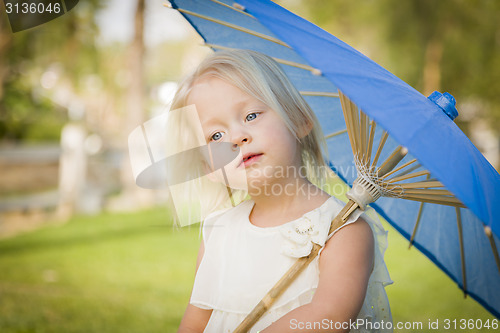 Image of Cute Baby Girl Holding Parasol Outside At Park