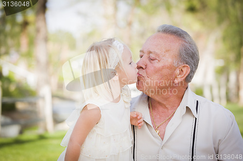 Image of Grandfather and Granddaughter Kissing At The Park