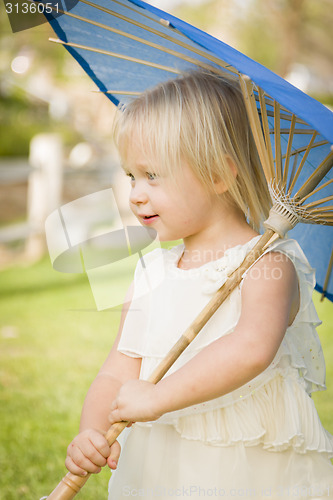 Image of Cute Baby Girl Holding Parasol Outside At Park