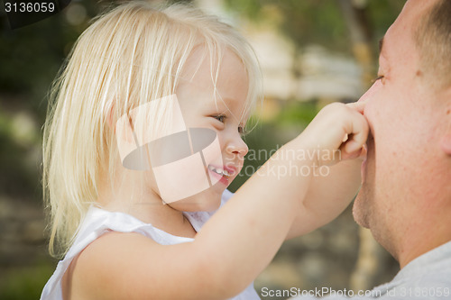 Image of Father Playing With Cute Baby Girl Outside at the Park