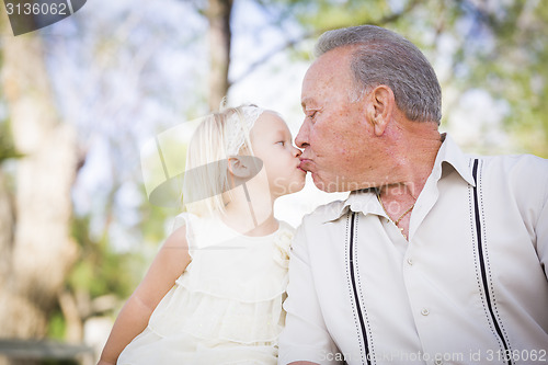 Image of Grandfather and Granddaughter Kissing At The Park