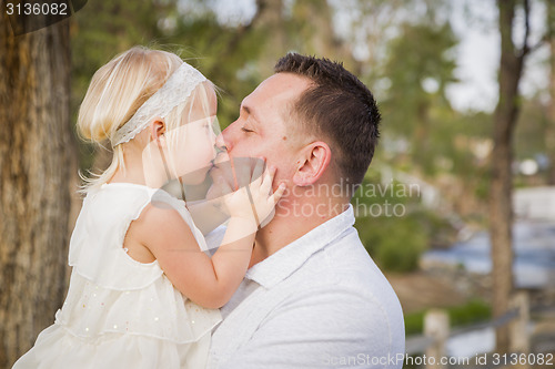 Image of Father Playing With Cute Baby Girl Outside at the Park