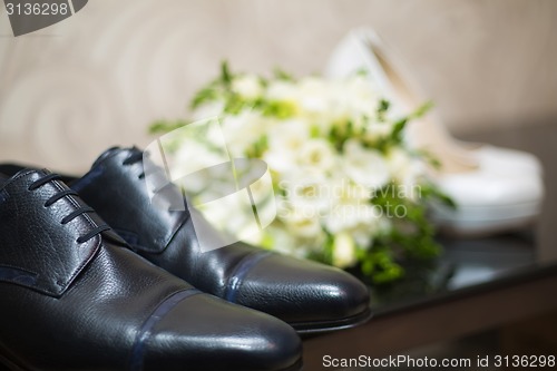 Image of Bride&#39;s and groom&#39;s shoes on parquet.