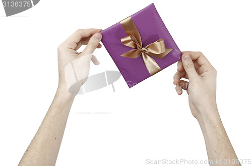 Image of Young man holding a present