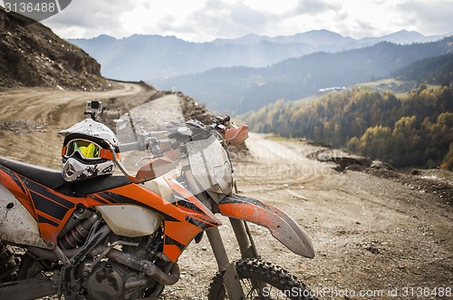 Image of Dirty enduro motorcycle motocross helmet on road