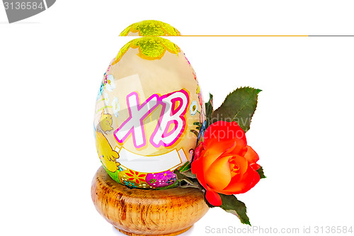 Image of Easter egg and flower rose among white background.