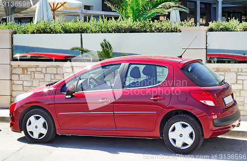 Image of A small car in the Parking lot near the hotel.