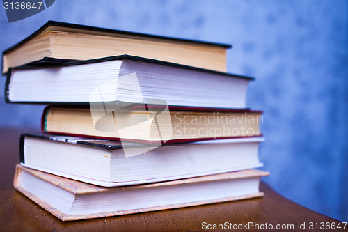 Image of stack of book on the wooden desk