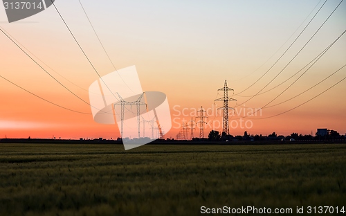 Image of Large transmission towers at sunset