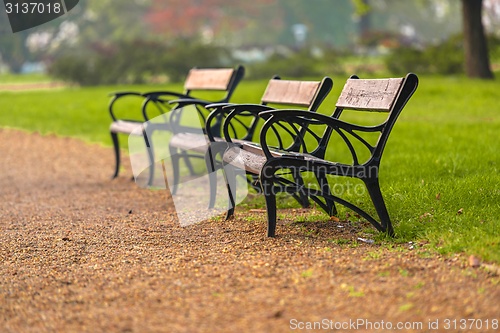 Image of Stylish bench in autumn park