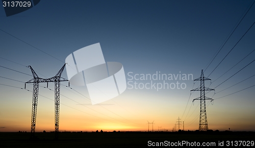 Image of Large transmission towers at sunset