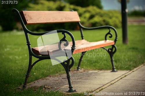 Image of Stylish bench in autumn park