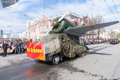 Image of Truck with model of I-16 plane prepares for parade