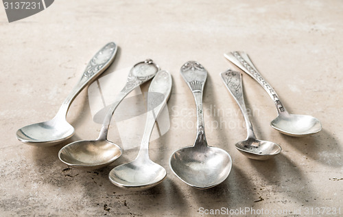 Image of various empty silver spoons