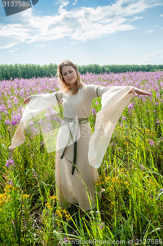 Image of Pretty sad girl on meadow