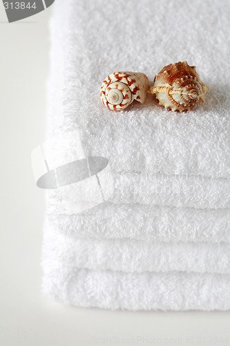 Image of White towels with seashell