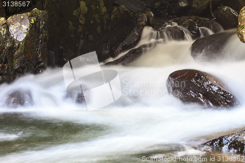 Image of waterfall and rocks covered with moss