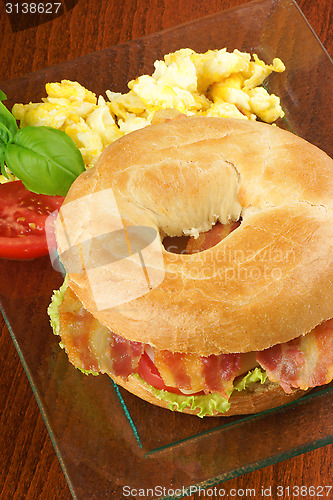 Image of Bacon and cheese bagel with scrambled eggs