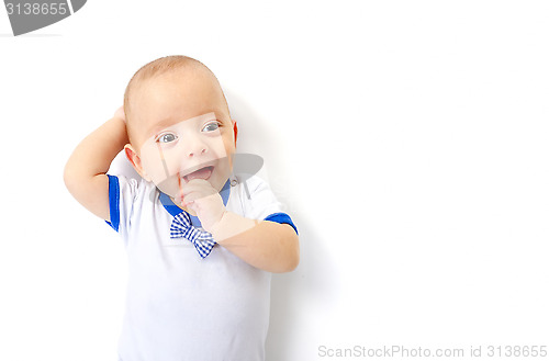 Image of baby boy lying on white floor