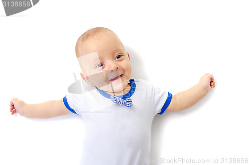 Image of baby boy lying on white floor