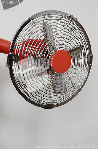 Image of retro metal fan on neutral background