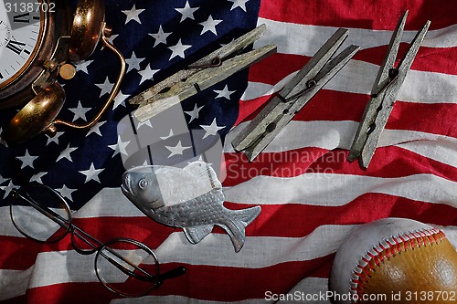 Image of vintage still life, the American flag, old alarm clock, glasses,