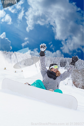 Image of Young girl Oversized sitting with your snowboard in the snow and would be