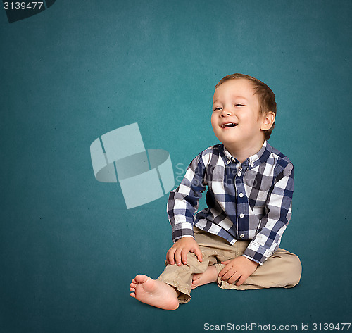 Image of Cute boy siting on the floor