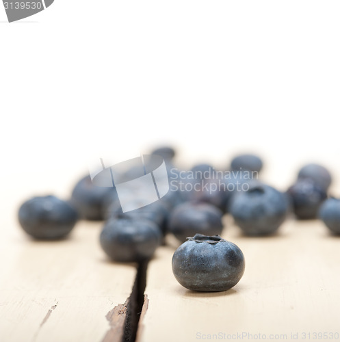 Image of fresh blueberry on white wood table