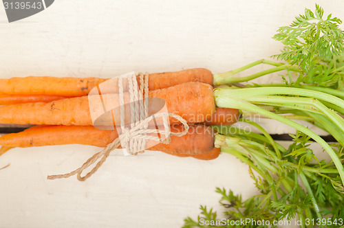 Image of baby carrots bunch tied with rope