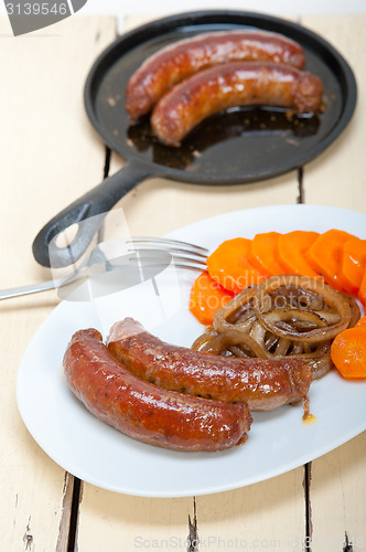 Image of beef sausages cooked on iron skillet 