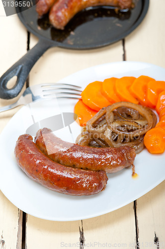 Image of beef sausages cooked on iron skillet 