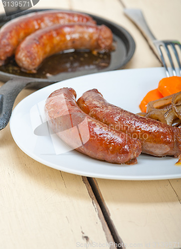 Image of beef sausages cooked on iron skillet 