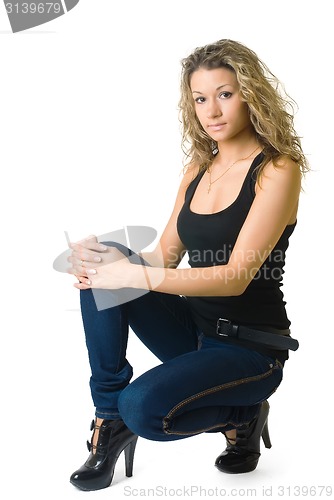 Image of Attractive curly girl in jeans