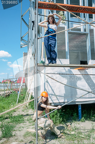 Image of Two attractive women on construction site