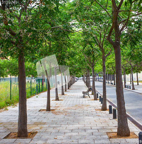 Image of walking alley with bench in a small town