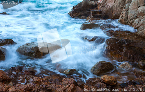 Image of waves of the sea and coastal rocks