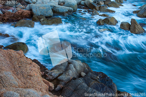 Image of waves of the sea and coastal rocks, surf