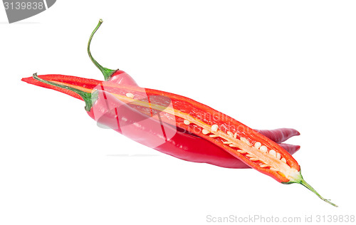 Image of Two whole and one half red chili peppers deployed